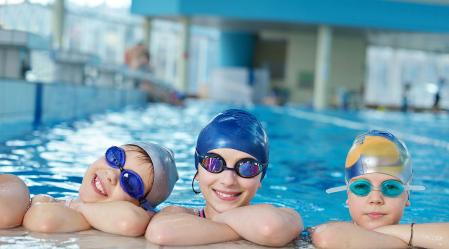 Swimmers on side of pool shutterstock 137683304